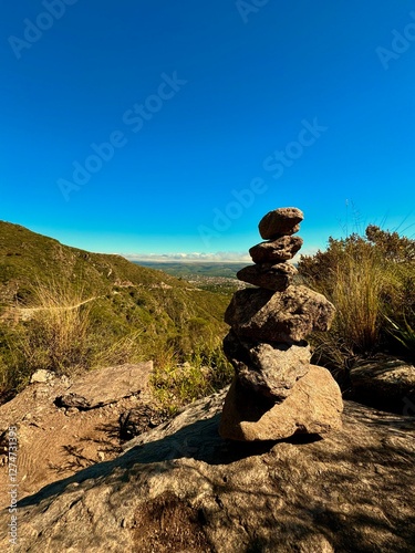 Milestone on the side of the trail in the mountain with the town of fonde