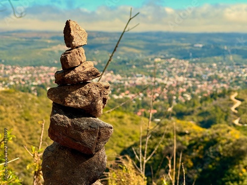 Milestone on the side of the trail in the mountain with the town of fonde