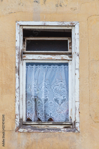 flower decoration in the curtain and rotten wooden window frame