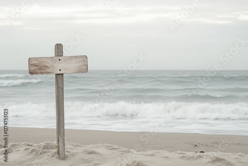 A weathered wooden signpost stands on a sandy beach near the ocean waves, evoking a sense of mystery and nostalgia