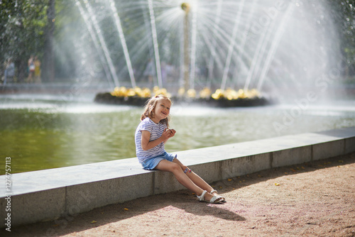 Adorable preschooler girl walking in Petergof, St. Peterburg, Russia. photo