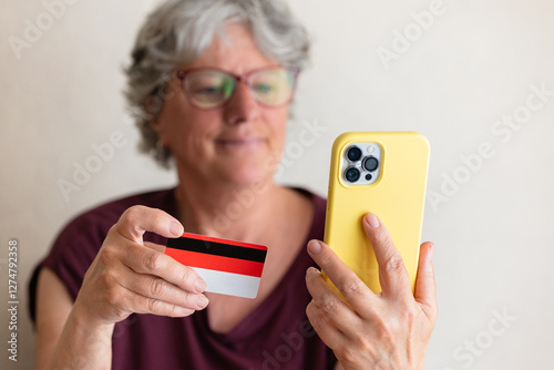 Senior Woman Using Smartphone for Online Shopping with Card
