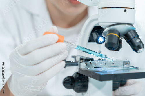Scientist analyze biochemical samples in advanced scientific laboratory. Medical professional use microscope look microbiological developmental of viral. Biotechnology research in science lab. photo