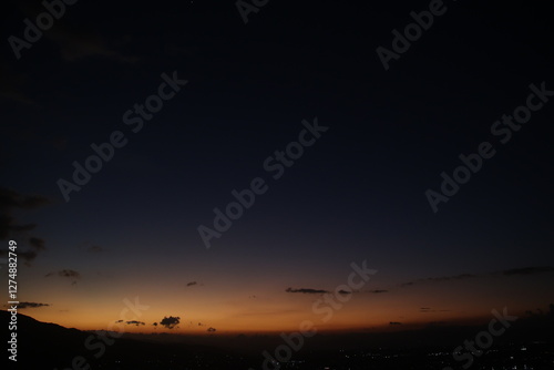 City lights glow under a dusky sky