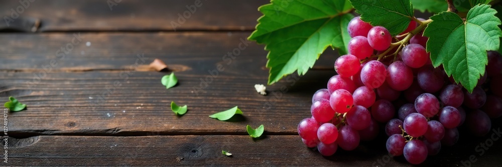 Dark wooden table with bunches of wild grapes and eucalyptus leaves, greenery, wild grapes, texture Dark wooden table with bunches of wild grapes and eucalyptus leaves, greenery, wild grapes, texture