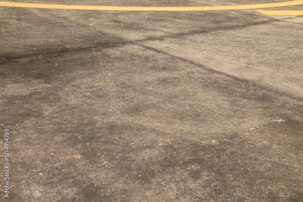 Fototapeta premium Airport floors are large areas of smooth grey concrete that stretch as far as the eye can see, with bright yellow stripes running across them to clearly divide the areas into sections. These yellow st