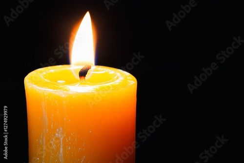 Single candle burning in a dark room. photo