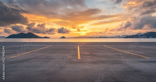 Fototapeta Naklejka Na Ścianę i Meble -  Empty seaside parking lot sunset; coastal city skyline