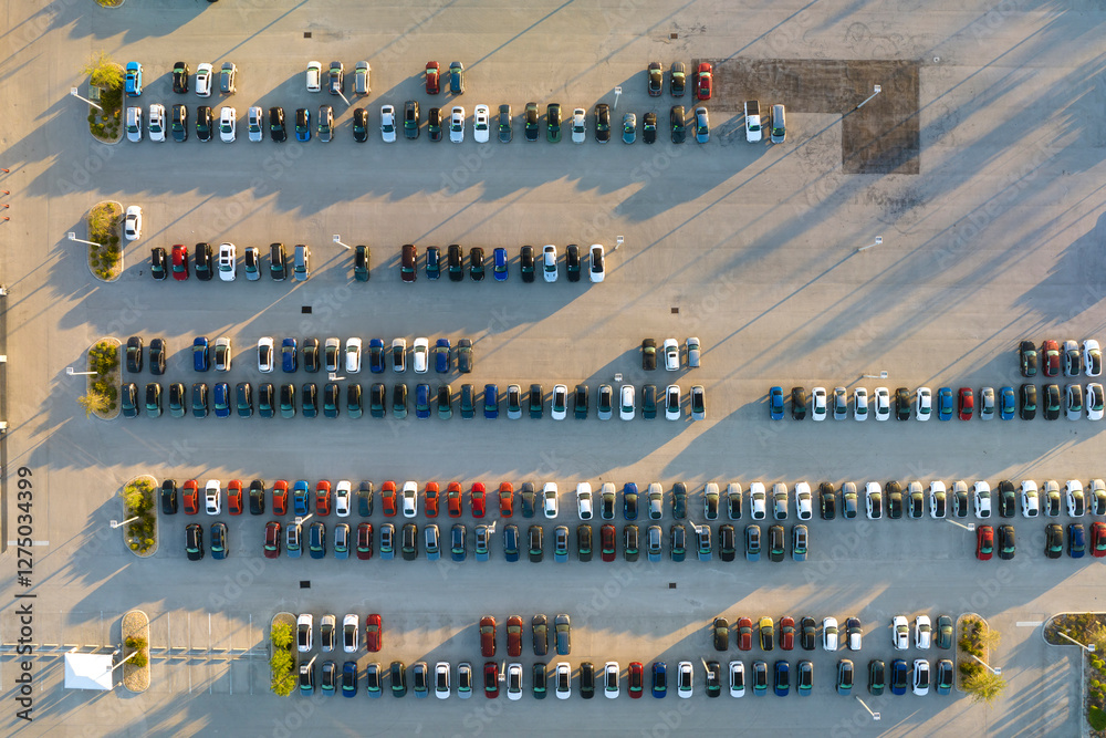 Obraz premium Aerial view of dealership parking lot with many brand new cars for sale. Development of american automotive industry concept