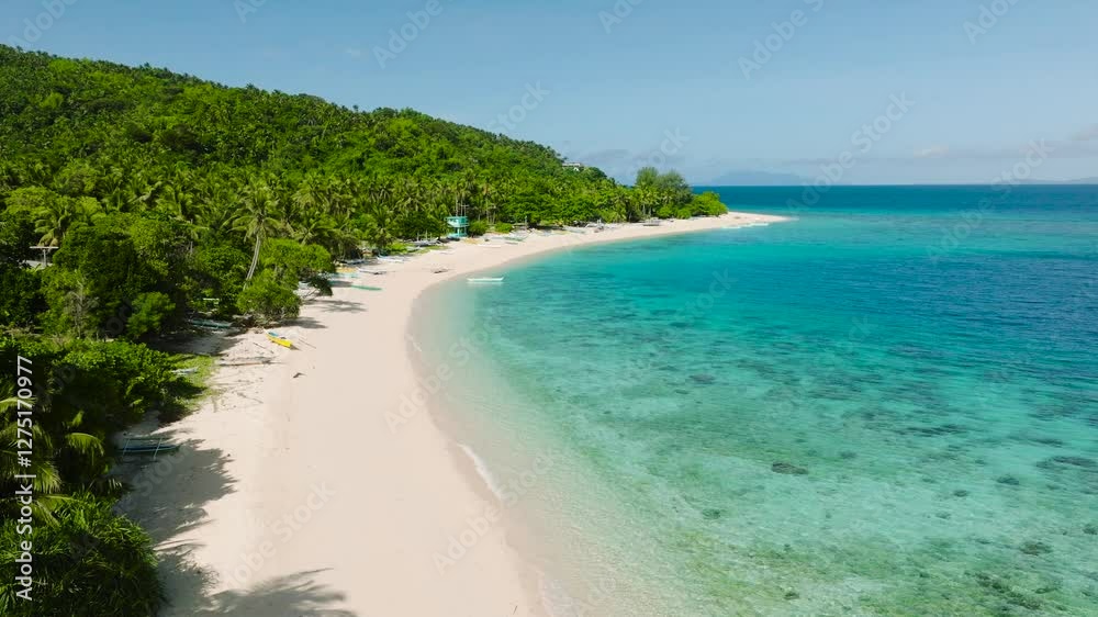Idyllic beach surrounded by lush forest, white sand, and crystal clear water. Cobrador Island, Romblon, Philippines. Idyllic beach surrounded by lush forest, white sand, and crystal clear water. Cobrador Island, Romblon, Philippines.