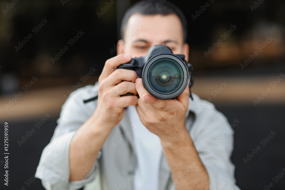 Male photographer with modern camera outdoors Male photographer with modern camera outdoors