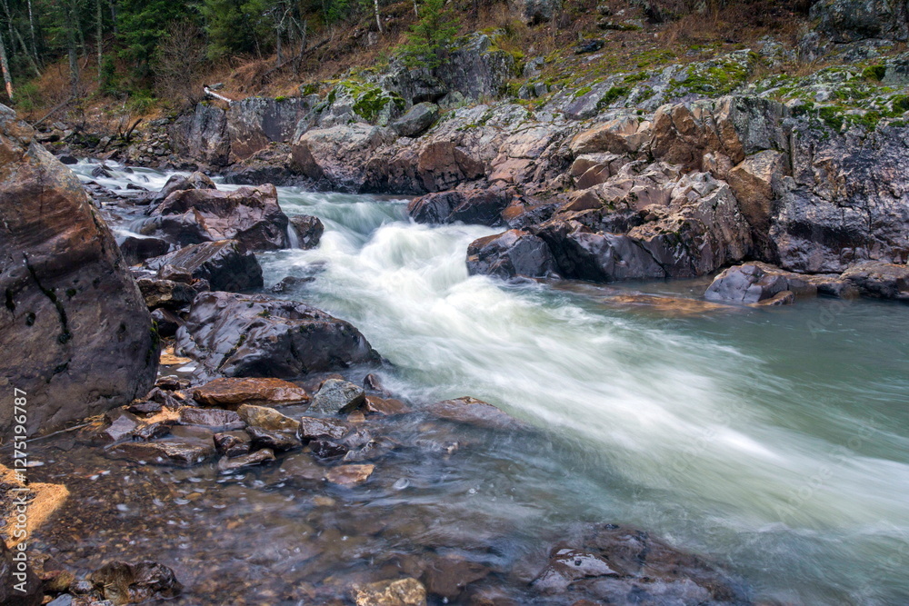 Fototapeta premium Water autumn landscape. A shallow fast mountain river with a rocky bottom. Ural.