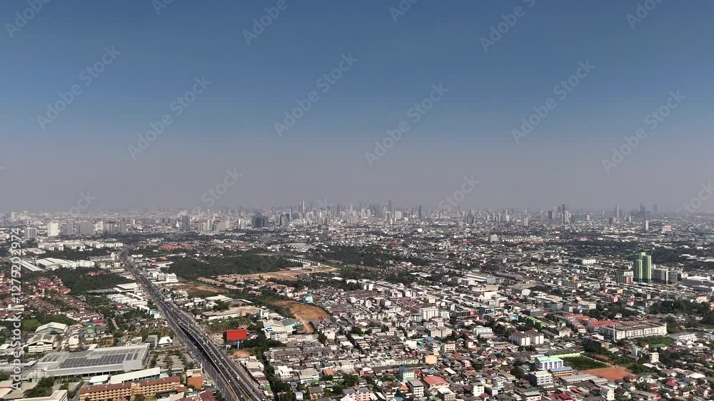 Suburban Bangkok area with freeway against skyscrapers Suburban Bangkok area with freeway against skyscrapers