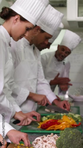 Team of chefs slicing vegetables