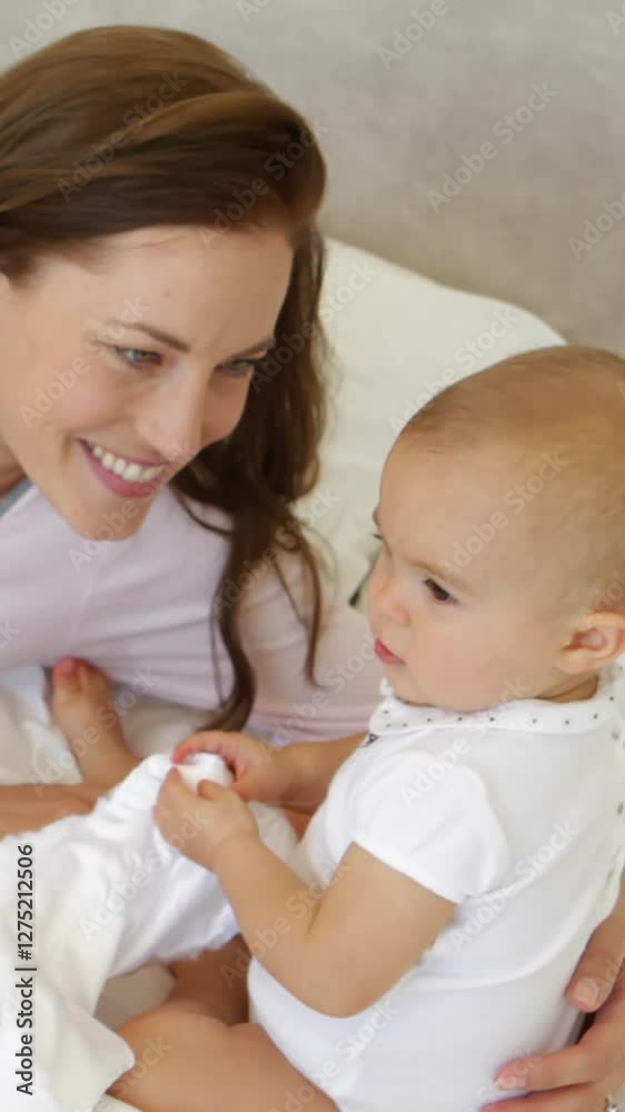 Mother playing with her baby daughter on the bed Mother playing with her baby daughter on the bed