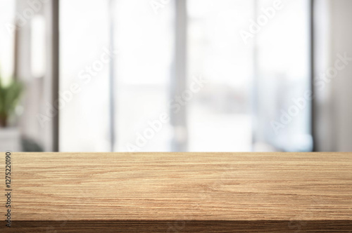 Wooden table top with copy space on blurred kitchen room interior background