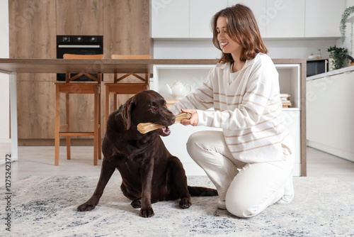 Young woman giving snack to...