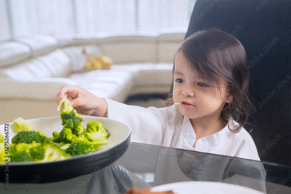 Young Child Enjoying Healthy Broccoli Meal at Home Young Child Enjoying Healthy Broccoli Meal at Home