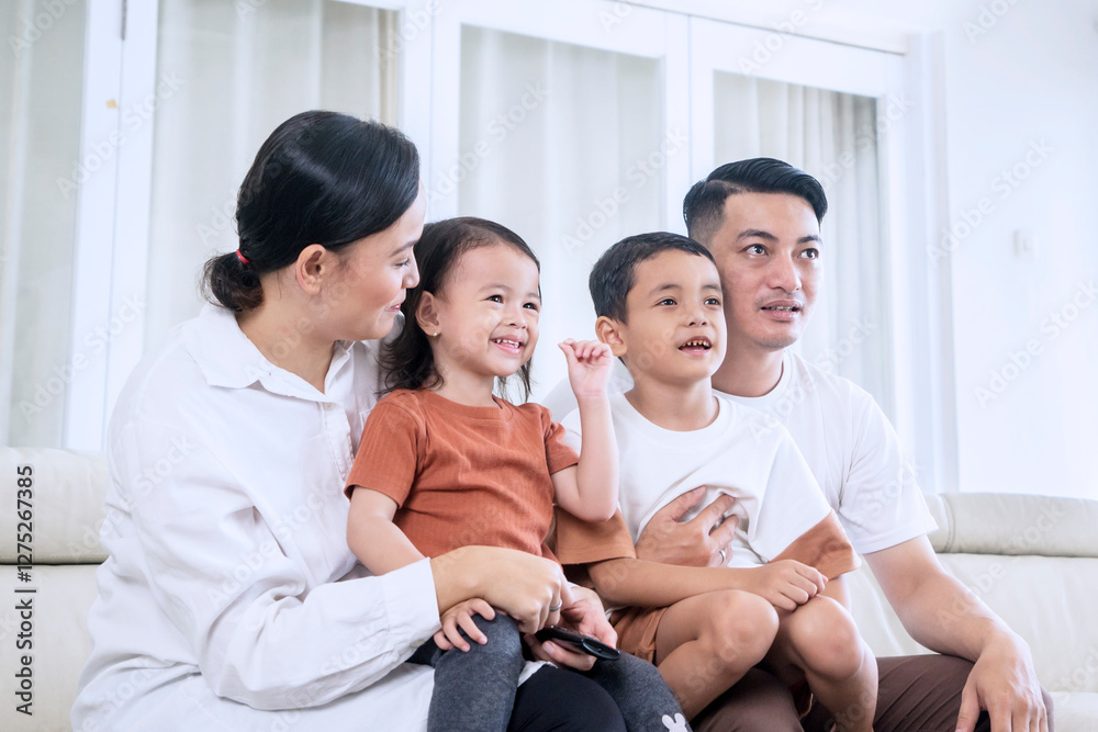 Happy Family Enjoying TV Time Together at Home Happy Family Enjoying TV Time Together at Home