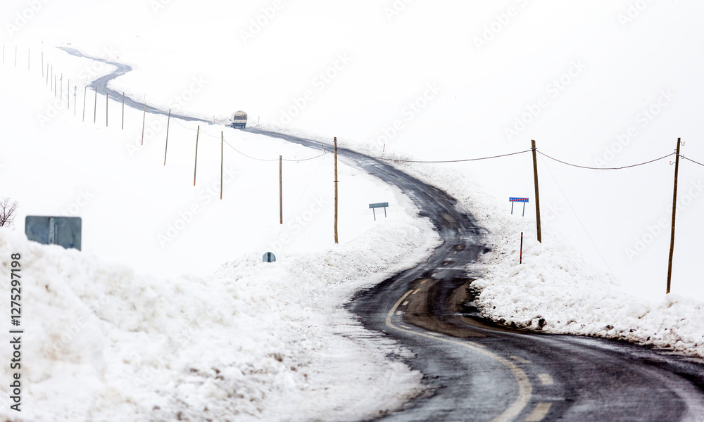 A road and electrical wires covered in snow