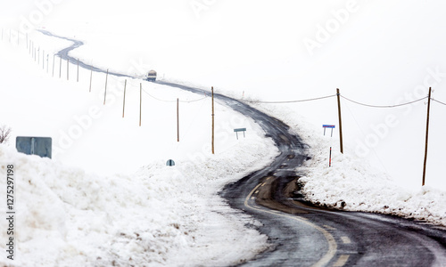 Obraz na płótnie A road and electrical wires covered in snow w salonie