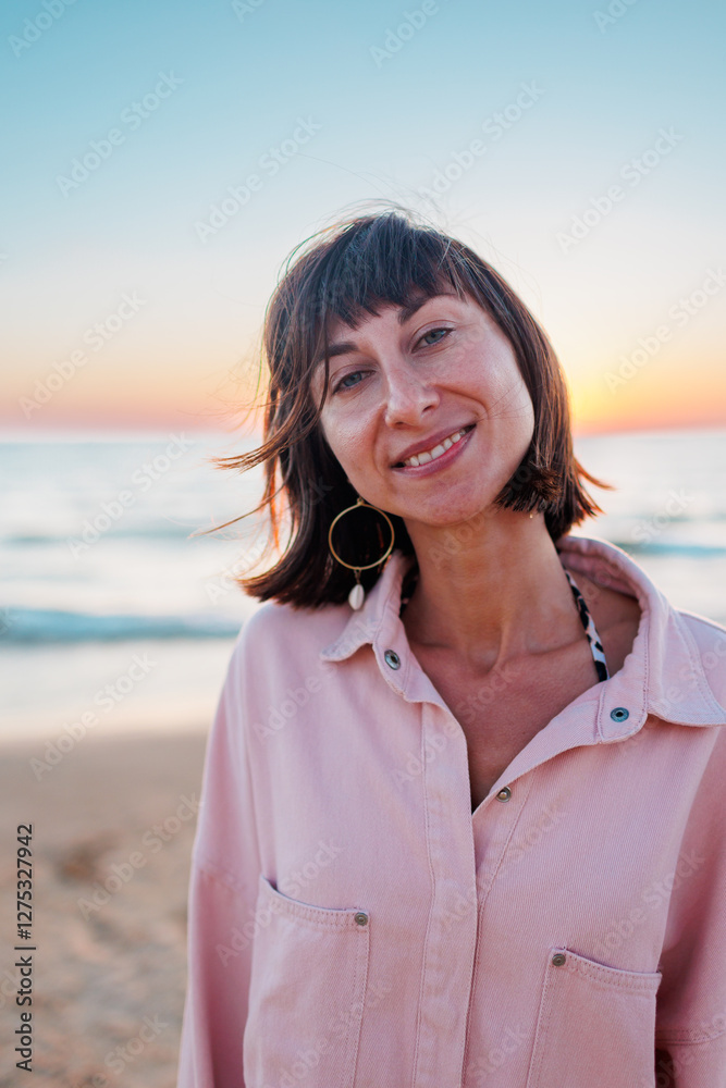 Summer mood. girl on the beach. happy young girl in a pink shirt and swimsuit resting on the beach. Happy woman. the girl is standing on the beach. . Summer mood. girl on the beach. happy young girl in a pink shirt and swimsuit resting on the beach. Happy woman. the girl is standing on the beach. .