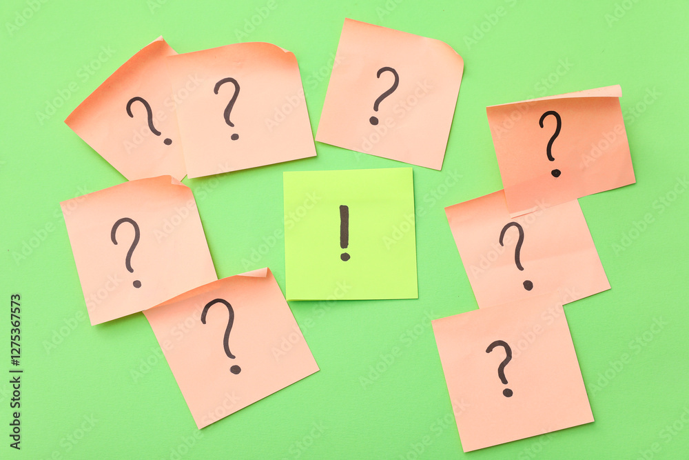 Sticky notes with question and exclamation marks on green background Sticky notes with question and exclamation marks on green background