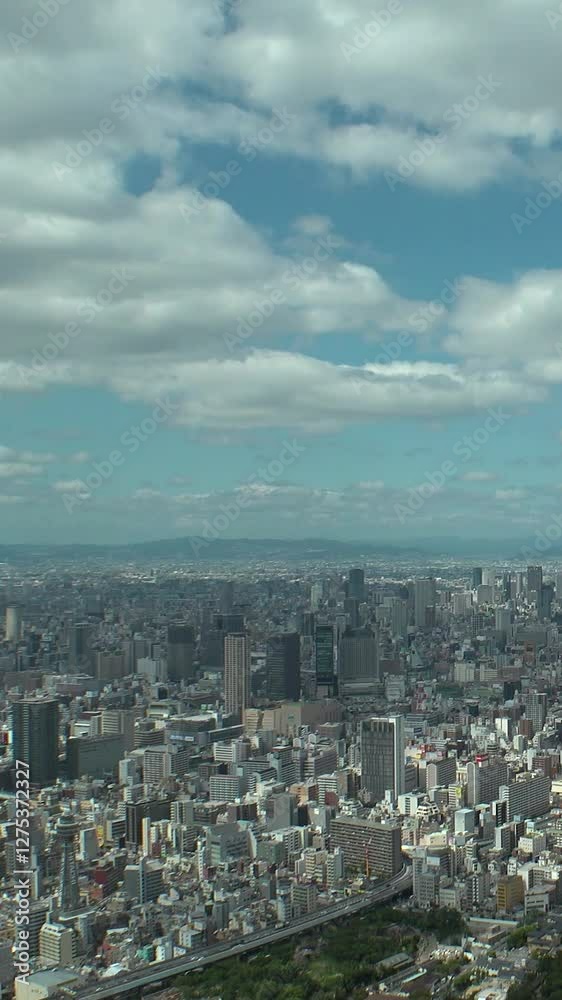OSAKA, JAPAN : Aerial high angle view of CITYSCAPE of OSAKA in daytime. View of building and street around Namba, Shinsaibashi, Umeda and Osaka train station. Vertical time lapse shot from above. OSAKA, JAPAN : Aerial high angle view of CITYSCAPE of OSAKA in daytime. View of building and street around Namba, Shinsaibashi, Umeda and Osaka train station. Vertical time lapse shot from above.