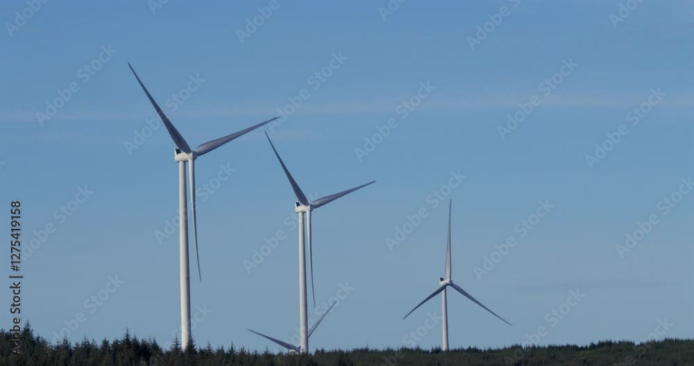 Wide shot of wind turbines rotating with blue sky on the A A4061 at Hendre'r Mynydd Car Park, Wide shot of wind turbines rotating with blue sky on the A A4061 at Hendre'r Mynydd Car Park,