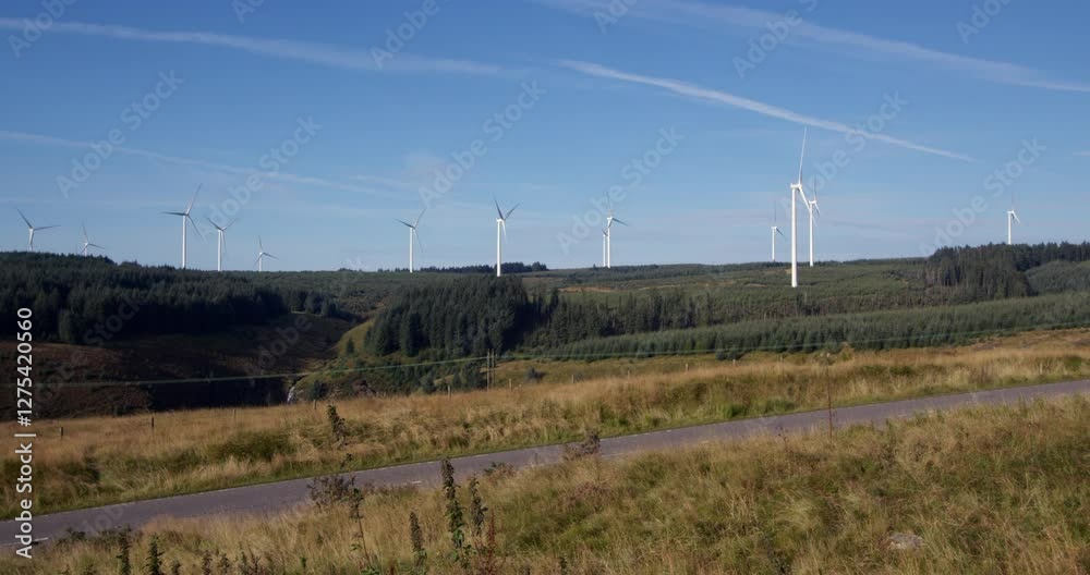 Extra Wide shot of multiple wind turbines rotating with blue sky on the A A4061 at Hendre'r Mynydd Car Park, Extra Wide shot of multiple wind turbines rotating with blue sky on the A A4061 at Hendre'r Mynydd Car Park,