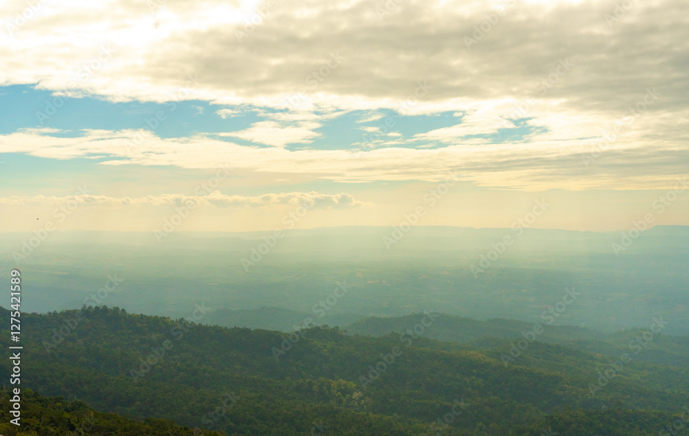 Naklejka premium View of Mountain Tops on a Warm Summer Day – Clouds in the Sky Over the Way to Phu Hin Rong Kla and Phu Lom Lo. Scenic Landscape of Phitsanulok, Thailand. Nature, Travel, and Adventure Destination.