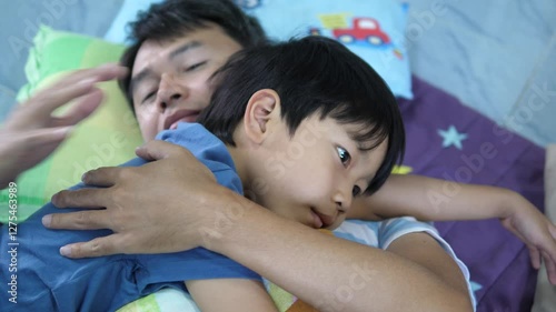 Father and son child hugging on bed with love and happy face at home.