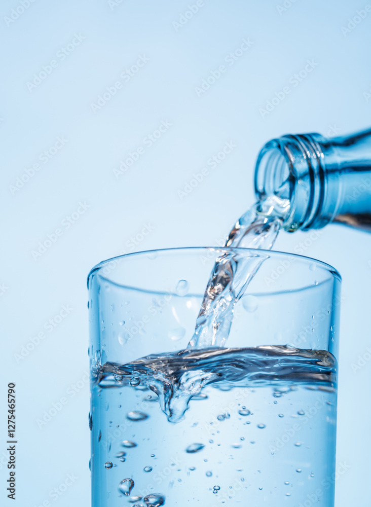 Crystal clear water being poured into a transparent glass, creating refreshing ripples and bubbles Crystal clear water being poured into a transparent glass, creating refreshing ripples and bubbles