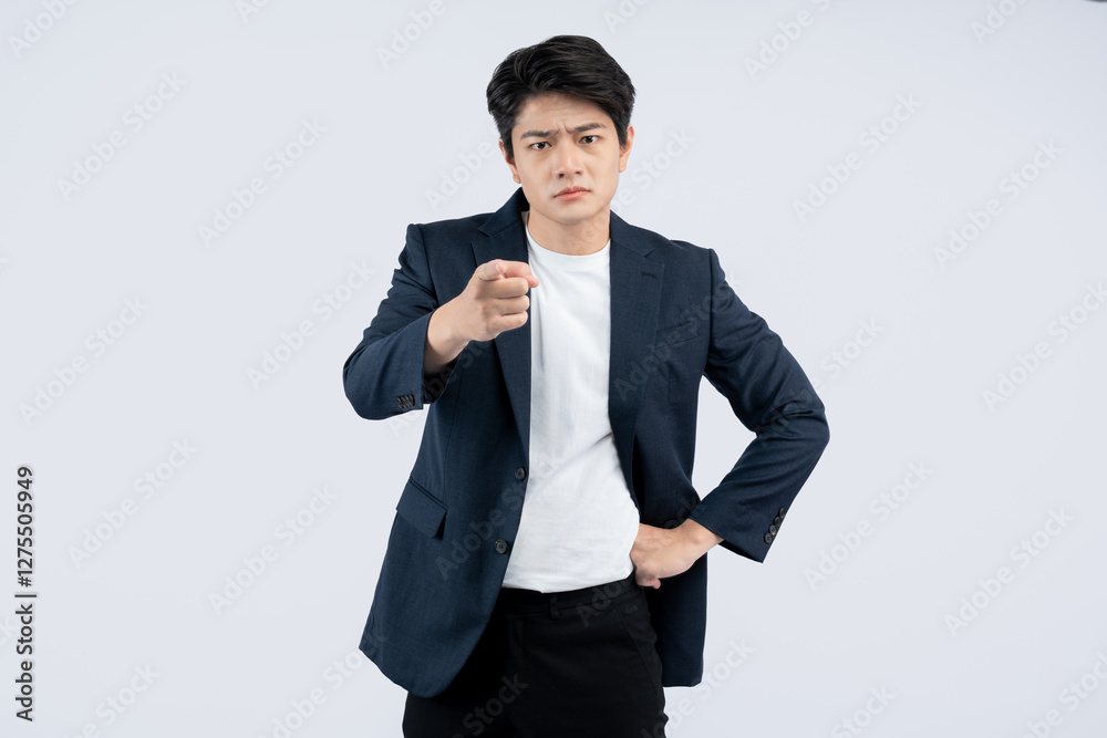 Portrait of young Asian business man posing on white background