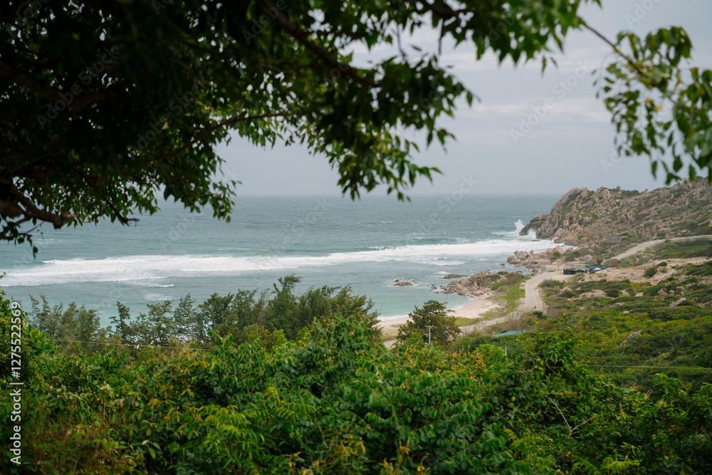 A stunning coastal view from Bình Ba Island, Vietnam, featuring lush green hills, winding roads, and turquoise waves crashing onto the sandy shore. The untouched landscape exudes tranquility A stunning coastal view from Bình Ba Island, Vietnam, featuring lush green hills, winding roads, and turquoise waves crashing onto the sandy shore. The untouched landscape exudes tranquility