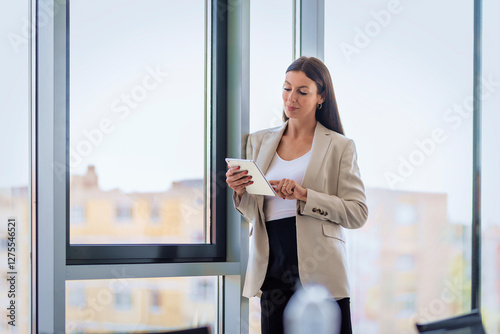 Wallpaper Mural Woman with touchpad in her hand standing in a modern office Torontodigital.ca