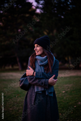 Woman walking at city park in an autum day
