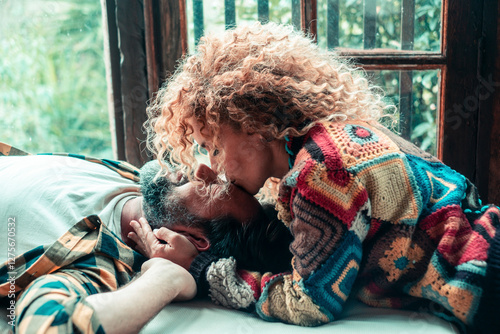Bild auf Leinwand Two adults in a loving relationship are having a relaxed moment at home, lying o