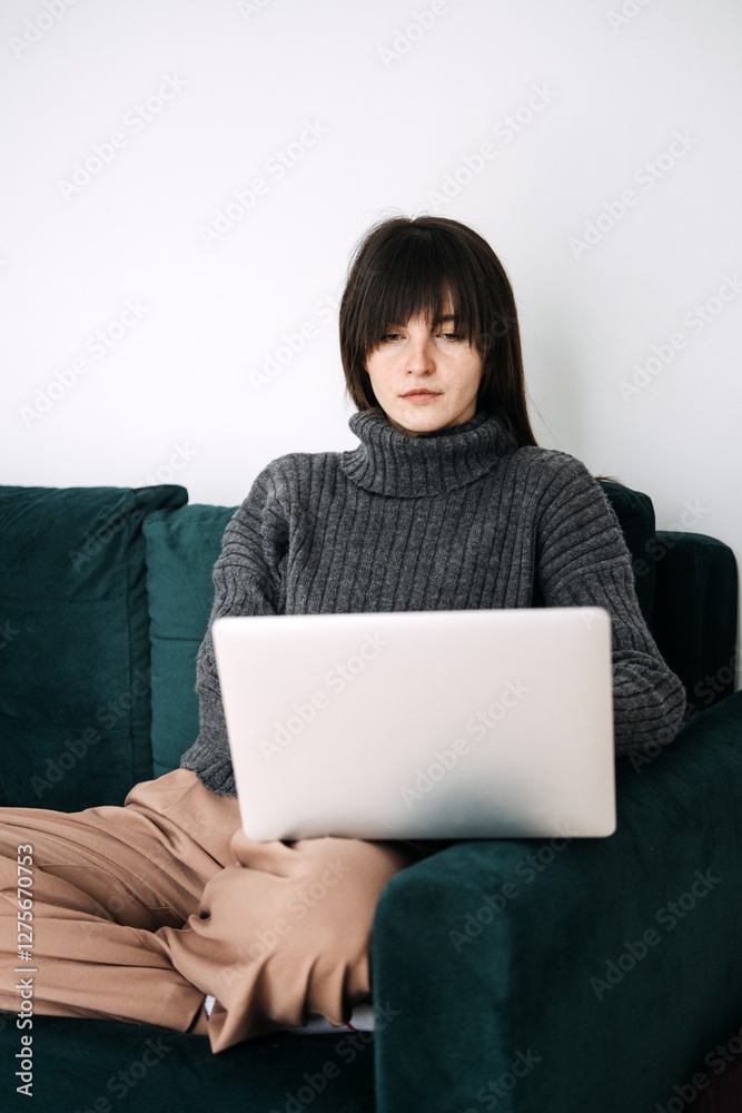 Woman focused on laptop, remote work from home, addressing work-related stress, mental health, solitude in modern work environments, productivity challenges. Woman focused on laptop, remote work from home, addressing work-related stress, mental health, solitude in modern work environments, productivity challenges.