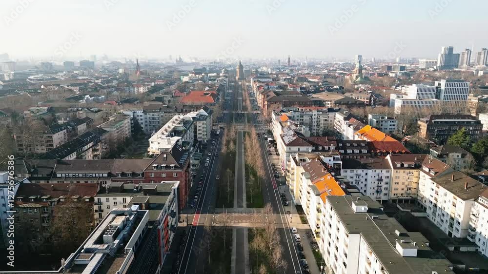 Drone flight over Mannheim's Augustaanlage towards the iconic Wasserturm on a clear, sunny winter day.
