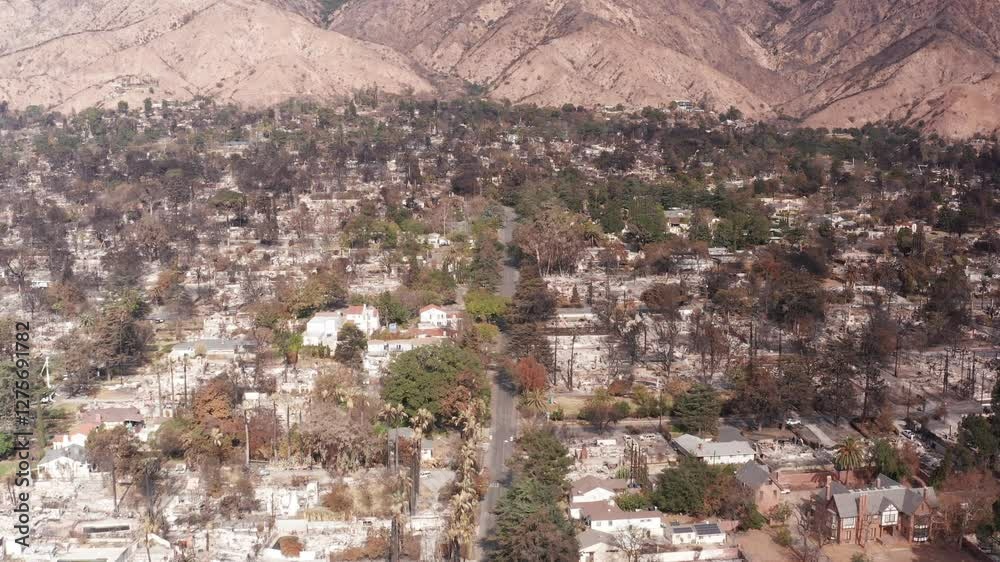 Low tilting up aerial shot of the charred landscape in the Eaton Fire burn scar in Altadena, California. 4K Low tilting up aerial shot of the charred landscape in the Eaton Fire burn scar in Altadena, California. 4K