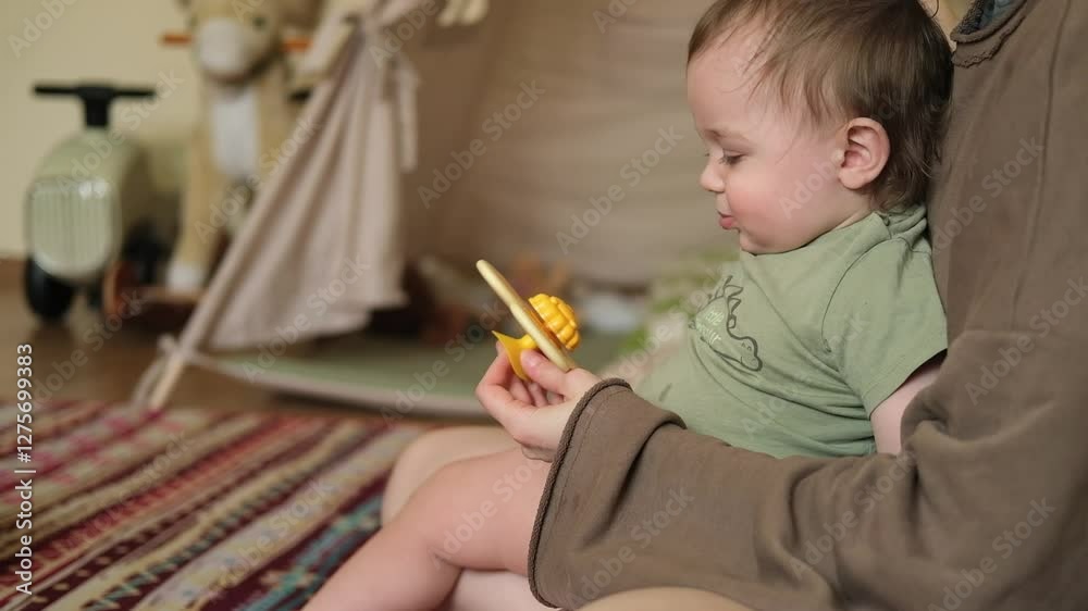 Adorable baby boy is playing with his mother mom at home, hugging, kissing. Family warm emotions. 