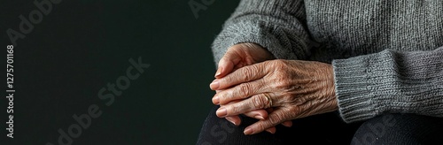 The image depicts a heartwarming scene of a young woman and a senior lady holding hands, with the background blurred to emphasize their intimate gesture in a wide panoramic shot