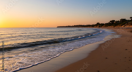 Golden Hour Beach Scene with Gentle Waves and Tranquil Atmosphere