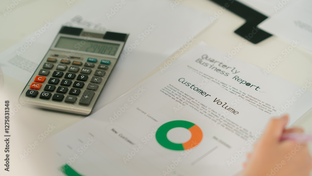 Quarterly business report with calculator and documents on desk Leader Teamwork stratup