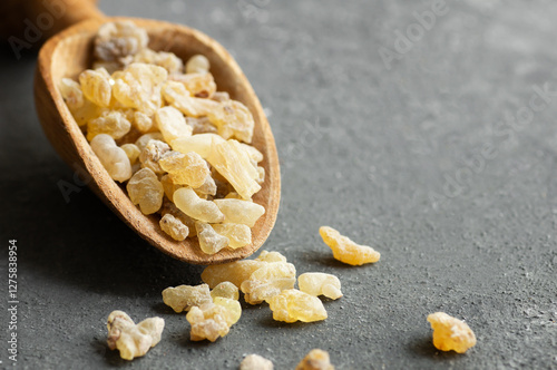 Natural organic frankincense or olibanum aromatic resins on dark background, used in incense and perfumes
