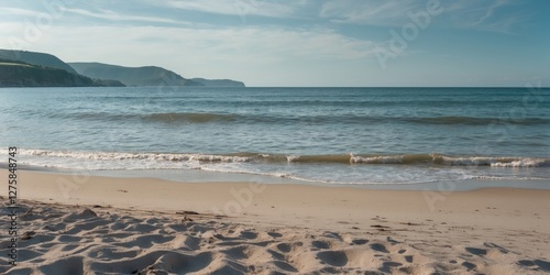 Tranquil Beach Scene with Gentle Waves and Clear Blue Sky Ideal for Summer Themes and Text Overlay photo