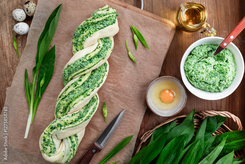 Homemade bread with wild garlic pesto on a wooden background.