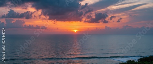 Serene Coastal Sunset with Dramatic Cloud Cover Over the Ocean and Inter Coastal Waterway
