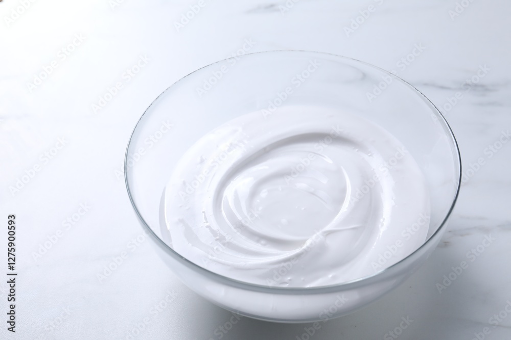 Bowl of whipped cream on white marble table Bowl of whipped cream on white marble table